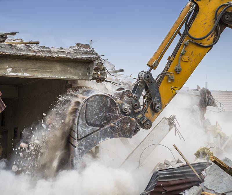 demolition of a building using an excavator